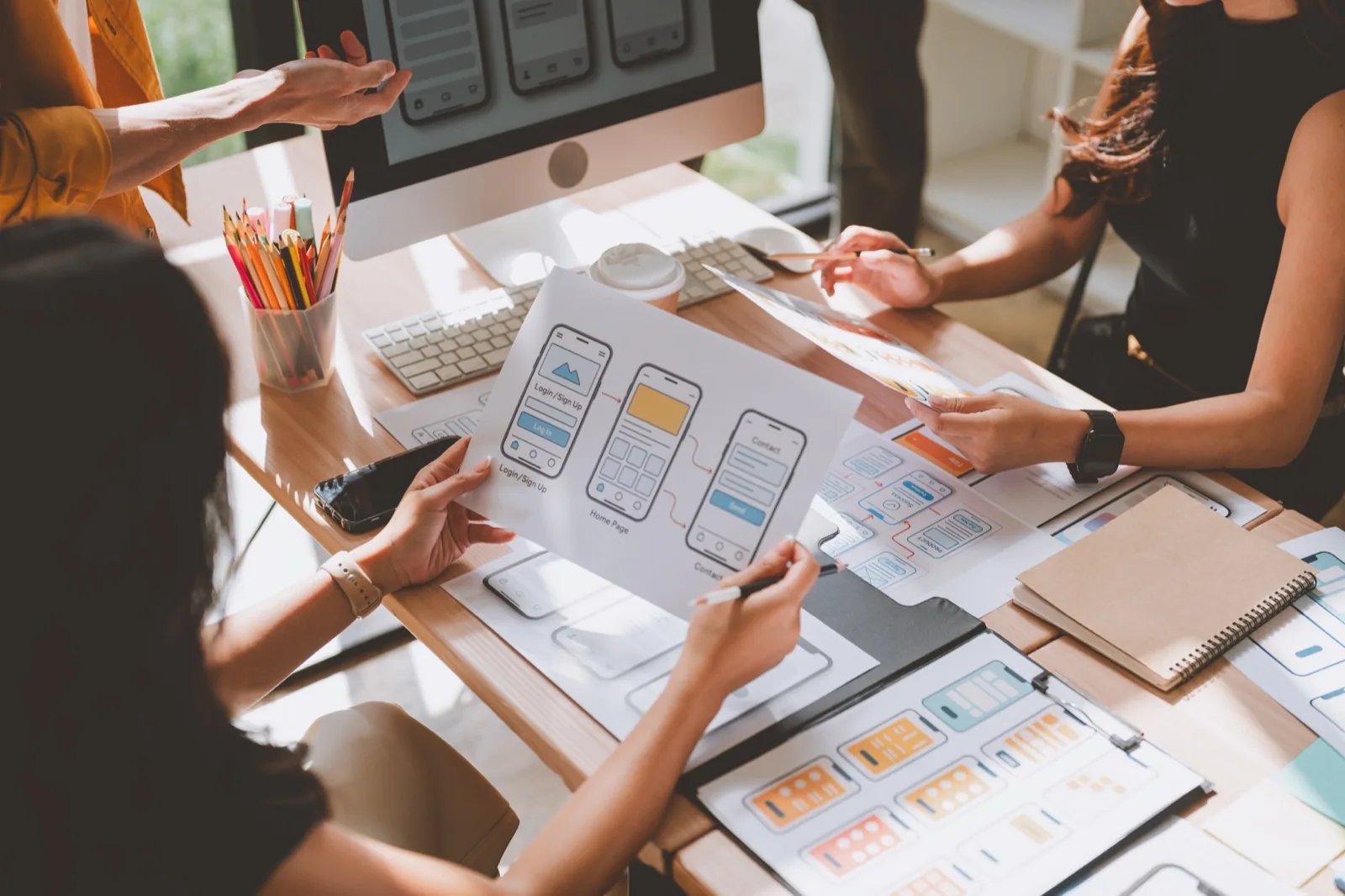 Designers collaborating on mobile UI mockups